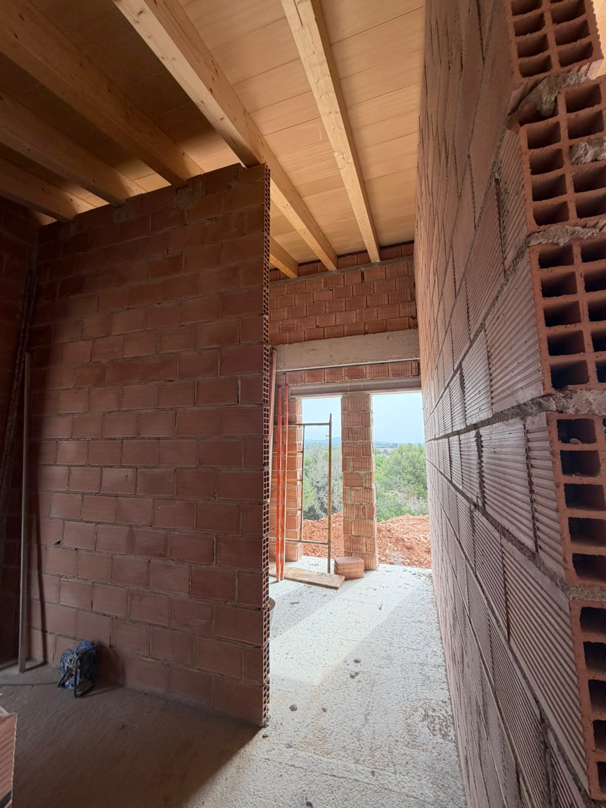Exposed-wood ceiling above the upper-floor rooms