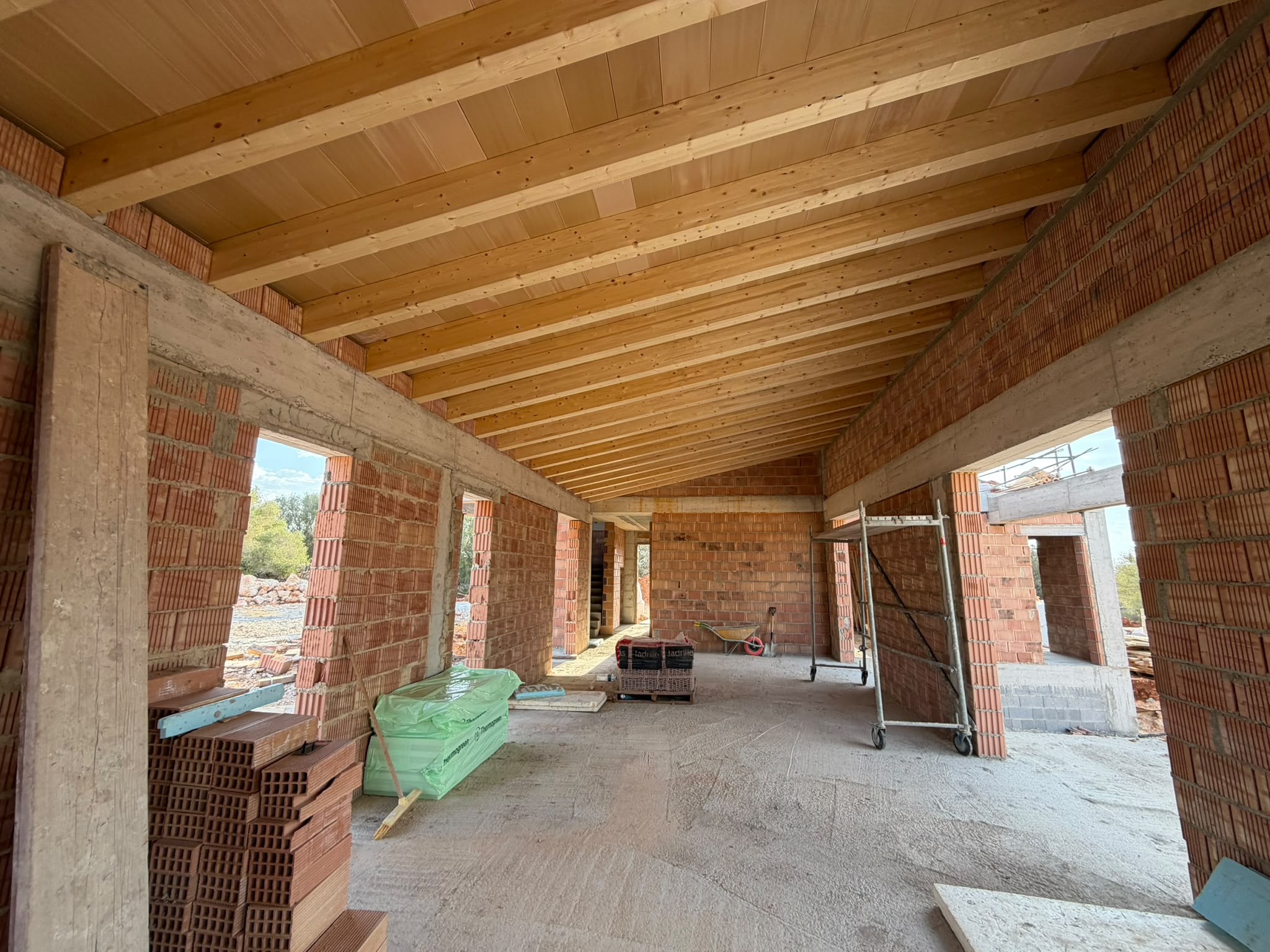 Open living area beneath exposed timber-beam ceiling